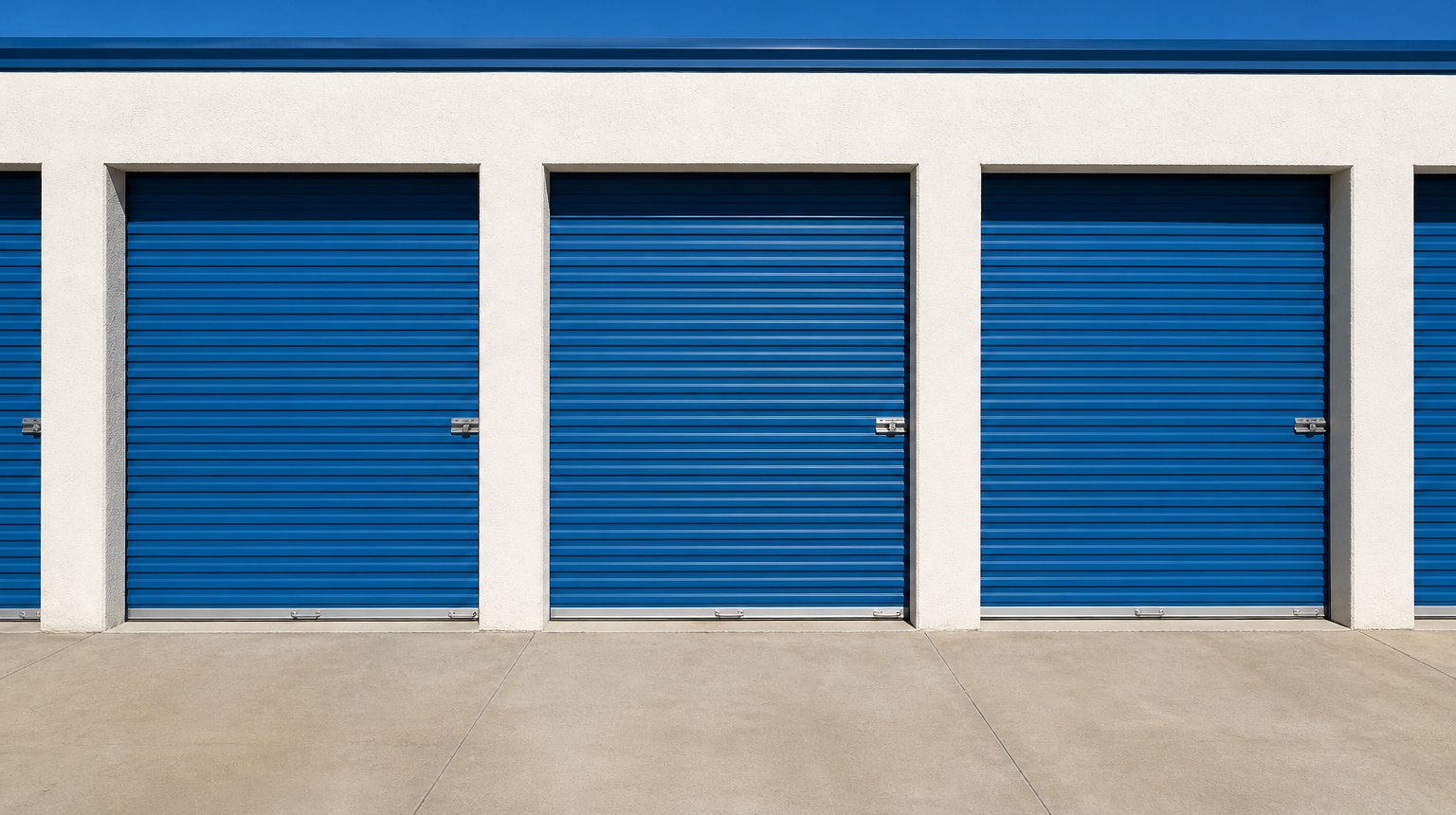 A row of blue roll-up doors at Barker Storages