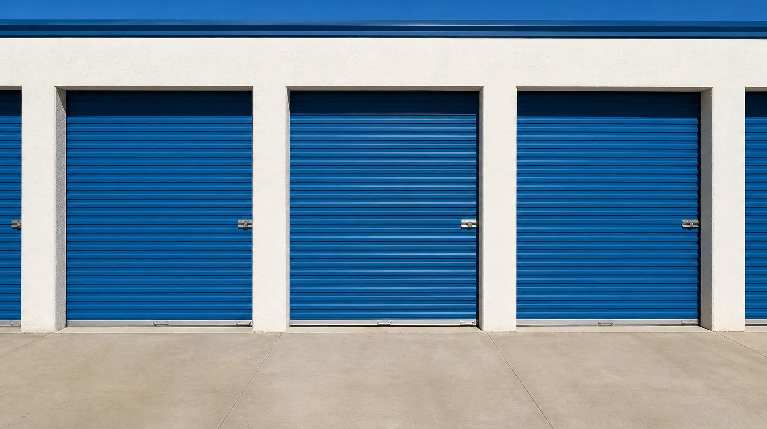 A row of blue roll-up doors at Barker Storage